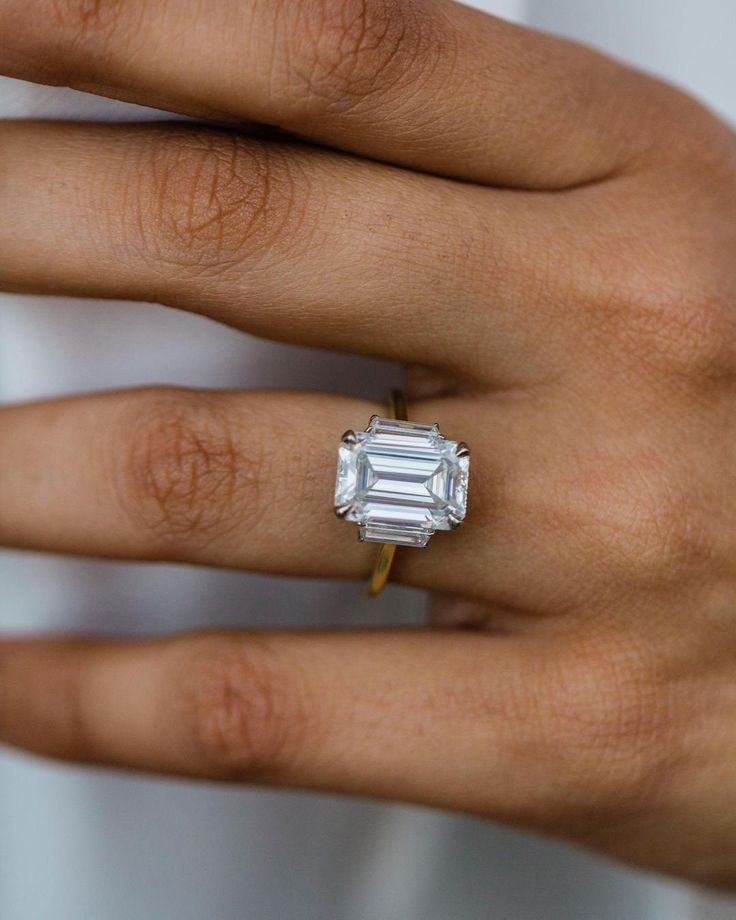 a woman's hand with a diamond ring on it