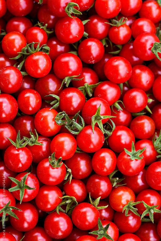 many red tomatoes are piled up together