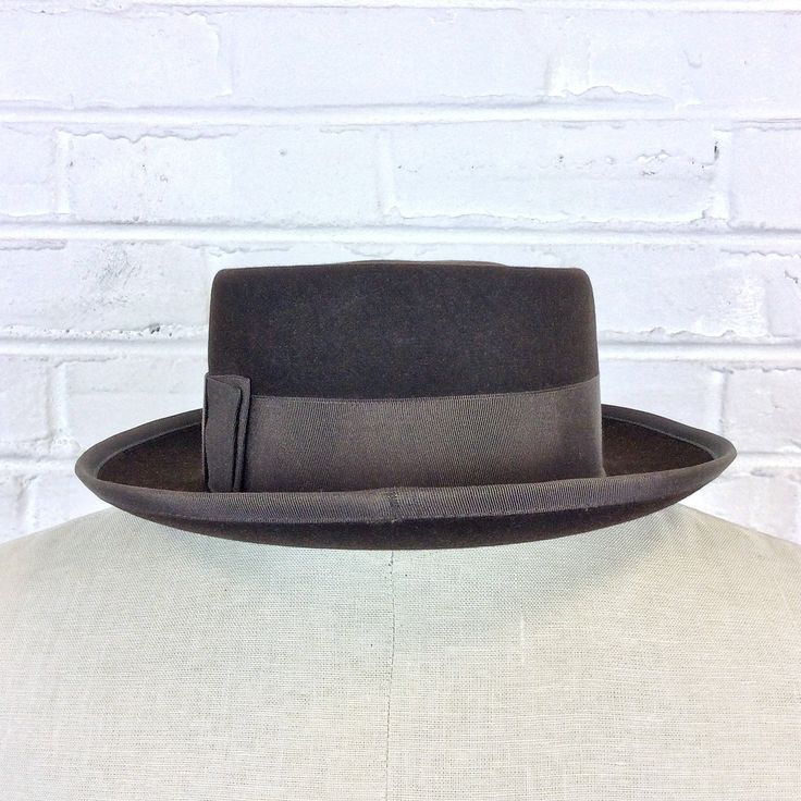 "Size 6 7/8 Vintage 1950s 1960s Adam Hats Carbon Brown Porkpie Fedora Hat For your consideration we have a vintage fedora from the '50s/'60s. Made by Adam Hats from a \"carbon brown\" fur felt, this \"Rugby\" model features a telescopic crown, brown grosgrain band and edge, leather sweatband, and rayon lining. There are a few spots on the hat band and a few stitches have come out of the leather sweatband. This is still a great hat and wonderful for anyone into slick bop midcentury style. Measure Retro Winter Fedora With Curved Brim, Retro Winter Fedora With Flat Brim, Retro Flat Brim Fedora For Winter, Retro Adjustable Fedora For Formal Occasions, Retro Formal Fedora With Wide Brim, Adjustable Retro Fedora For Formal Occasions, Retro Wide Brim Fedora For Formal Occasions, Winter Retro Adjustable Fedora, Retro Curved Brim Felt Hat For Winter