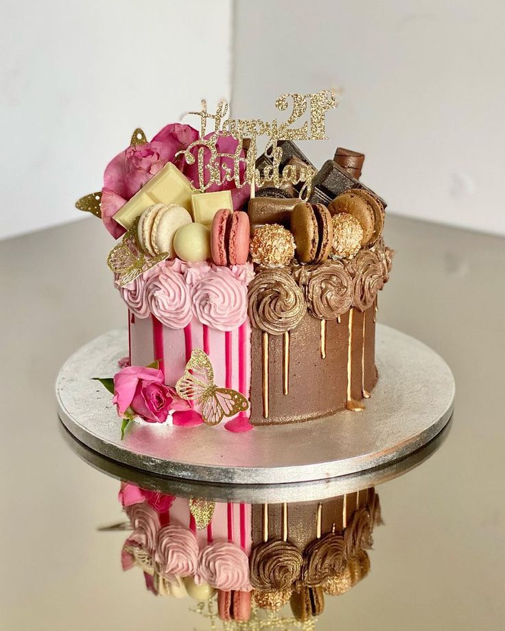 a cake decorated with pink and gold icing