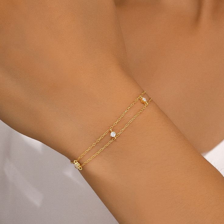 Elevate your style with the 925 Sterling Silver Minimalist Zircon Bracelet. This elegant bracelet is adorned with AAAAA zircon stones and crafted from high-quality 925 sterling silver, offering a timeless and hypoallergenic design. With a delicate 17cm+3cm adjustable chain, it’s perfect for adding a touch of sophistication to any outfit, whether casual or formal. Ideal for women seeking minimalist, elegant, and high-fashion jewelry. Specification:Materials: 925 Sterling Silver Plated With 18K Go Dainty Cubic Zirconia Sterling Silver Bracelet For Anniversary, Minimalist Sterling Silver Bracelet In Diamond White, Elegant Sterling Silver Bracelet With Delicate Chain, Minimalist Diamond White Sterling Silver Bracelet, Modern Cubic Zirconia Chain Bracelet For Gift, Modern Cubic Zirconia Chain Bracelet As Gift, Elegant Bracelets With Delicate Cubic Zirconia Chain, Delicate Cubic Zirconia Bracelets With Delicate Chain, Elegant Cubic Zirconia Bracelet With Delicate Chain