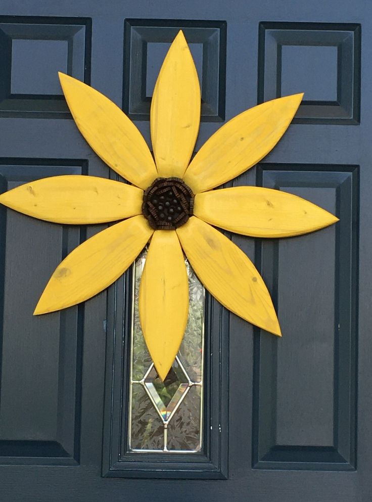 a yellow flower on the front door of a house