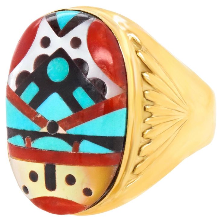 a gold ring with colorful designs on it