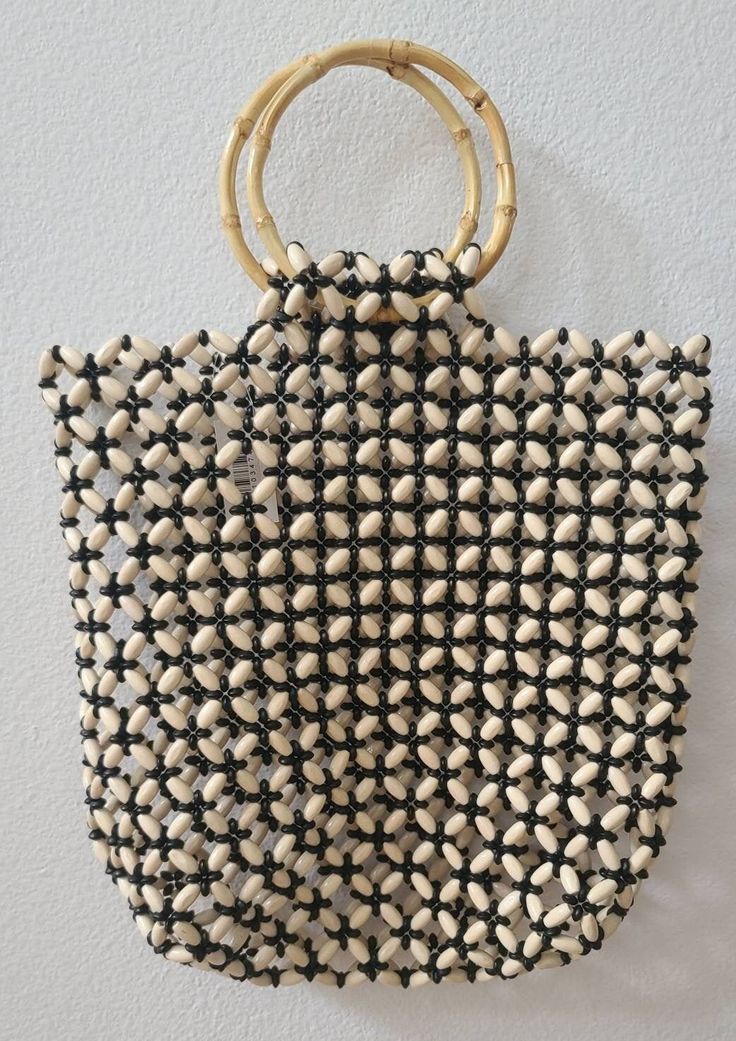 This wooden bag is made of bamboo material and natural beads.  It is lightweight and perfect for the beach. The size is approximately 26 inches in length and 12 inches wide. NOTE: THIS ITEM SHIPS WITHIN THE US ONLY Summer Beaded Rectangular Beach Bag, Beaded Beach Bags For Beach Season, Summer Vacation Beaded Beach Bag, Summer Vacation Beaded Shoulder Bag, Beaded Crochet Beach Bag For Summer, Summer Beaded Crochet Bag For Daily Use, Summer Beach Beaded Crochet Bag, Summer Beach Crochet Bag With Beaded Detail, Summer Beach Crochet Bag With Beads