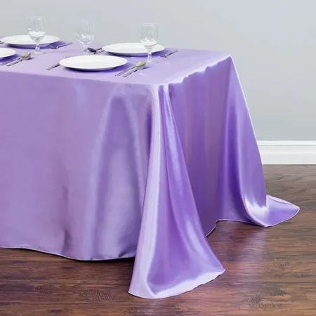 a purple table cloth with white plates on it