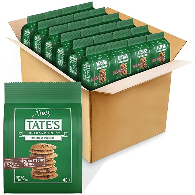 an open box of tates cookies with chocolate chips on the bottom and in front