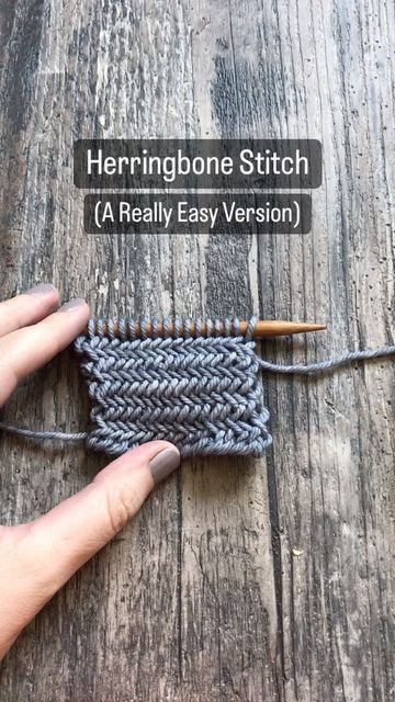 the herringbone stitch is being worked on by someone using their fingers to knit it