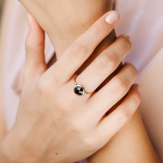 Black onyx 14K gold ring. A dainty, delicate black onyx gemstone ring, ideal for stacking for every woman who loves elegance. An excellent choice for anniversary gift or birthday gift for her. 100% handcrafted with love!D E T A I L S● Metal: 14K solid gold, 14K white gold or 14K rose gold● Gemstone: Black Onyx, briolette cut● Stone Diameter: 8mm (0.31in), 10mm (0.4in) and 12mm (0.5in) R I N G ∙ S I Z I N GFor General Reference:● we use standard US Ring Sizing● an average women's ring finger is s Adjustable Black Spinel Jewelry For Gifts, Minimalist Onyx Gemstone Ring, White Gold Round Jewelry With Black Enamel, Black Dainty Ring As Gift, Modern Black Jewelry With Bezel Setting, Black Birthstone Jewelry For Promise Ring, Elegant Adjustable Onyx Rings, Dainty Black Ring As Gift, Dainty Black Ring For Gift