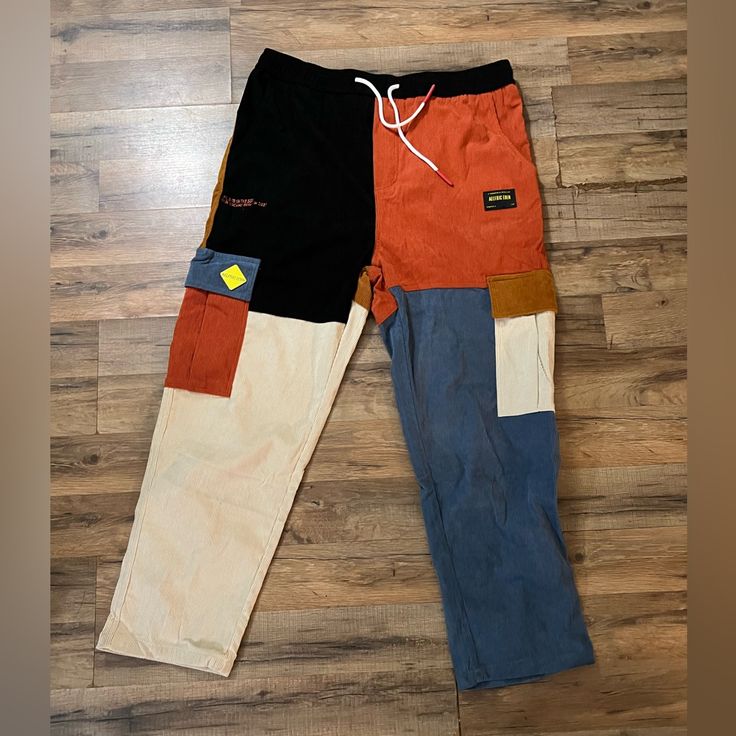 New With Tags Baggy Cotton Cargo Pants With Patchwork, Multicolor Straight Leg Patchwork Pants, Color Block Cotton Jeans For Streetwear, Multicolor Straight Leg Pants With Patchwork, Multicolor Patchwork Straight Leg Pants, Multicolor Denim Patchwork Pants, Color Block Cotton Bottoms For Fall, Multicolor Patchwork Denim Pants, Fall Color Block Cotton Bottoms