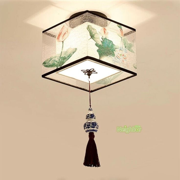 a lamp hanging from the ceiling with a tasseled light fixture attached to it