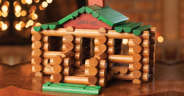 a wooden house made out of logs on a table