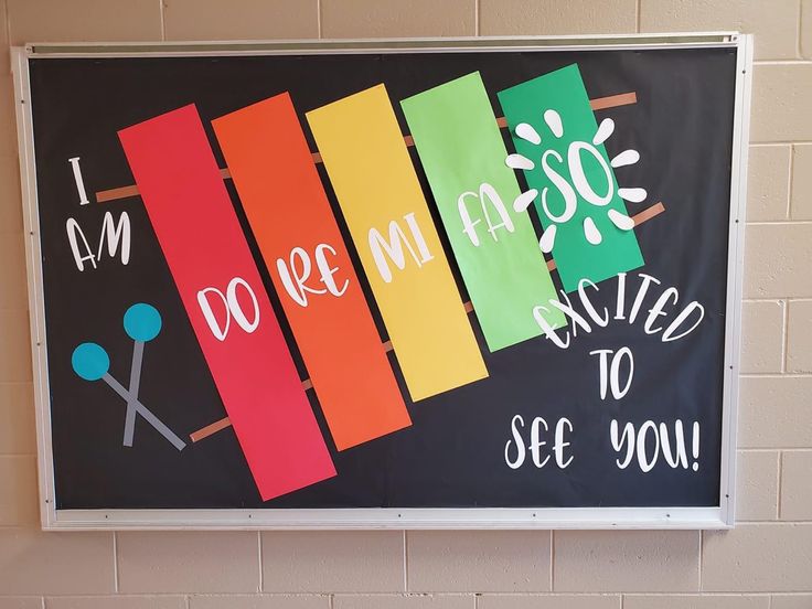 a bulletin board hanging on the wall in a school hallway with words written on it