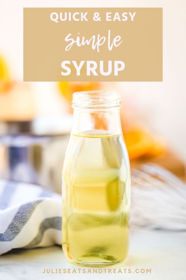 a glass jar filled with liquid sitting on top of a counter next to a towel