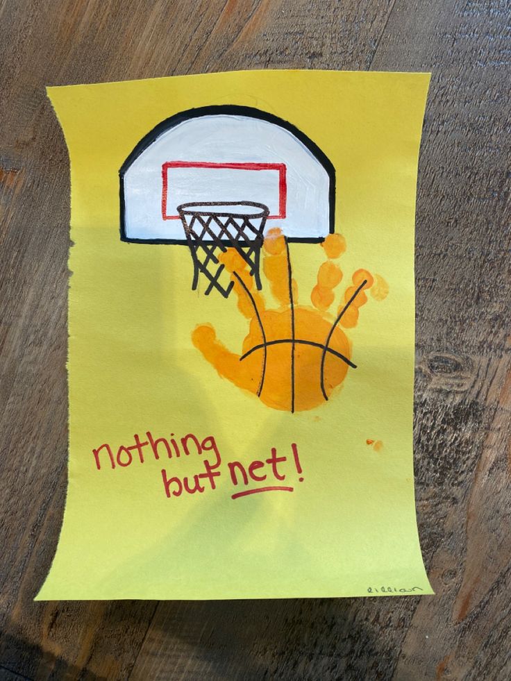 a handprinted basketball hoop with the words nothing but net written on it is hanging from a piece of yellow paper