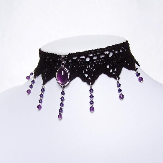 The elegant Angelique lace choker features a natural gemstone Amethyst pendant complemented by shimmering Amethyst purple Swarovski crystal beads. The main pendant of this elegant lace choker is set with a natural gemstone Amethyst Cabochon. From the front 7 points of the lace flow strands of shimmering Amethyst purple Swarovski crystal beads finished off with a 4mm round Amethyst natural gemstone. The lace is finished off securely with an extender chain which allows the necklace/choker to be wo Steampunk Choker, Purple Choker, Gothic Choker Necklace, Purple Goth, Gothic Choker, Gothic Lace, Lace Choker Necklace, Gothic Chokers, Purple Collar