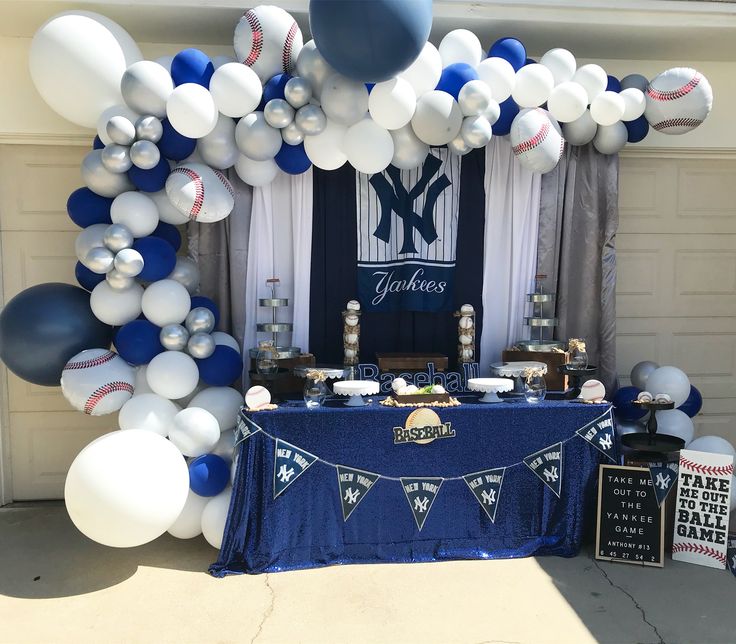 a table with balloons and baseballs on it