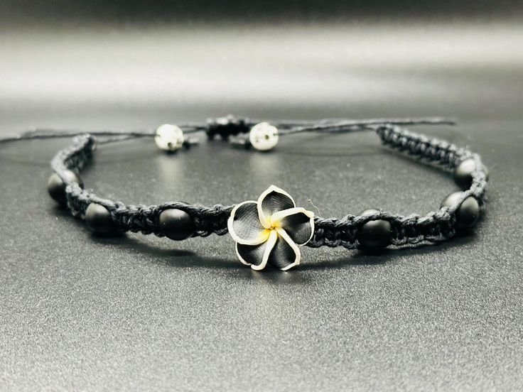 Matte black Onyx (natural) stones Plumeria hawaiian Flower Beautiful beaded hemp choker! * Hand-crafted square knot macrame * Adjustable * Opens up to 31" to fit overhead * 100% 1mm hemp cord * Slide knot closure for easy removal This hemp choker is made in traditional macrame square knots with black hemp and with natural matte onyx stones . Each of these beachy boho choker necklace is made adjustable for OSFM. Please message me with any questions. Thank you for choosing handmade and supporting Hand Wrapped Black Jewelry For Beach, Hand Wrapped Black Beach Jewelry, Black Bohemian Jewelry With Adjustable Cord, Bohemian Black Jewelry With Adjustable Cord, Black Spiritual Jewelry For The Beach, Spiritual Black Jewelry For Beach, Spiritual Black Jewelry For The Beach, Bohemian Black Flower Jewelry, Adjustable Black Flower Jewelry