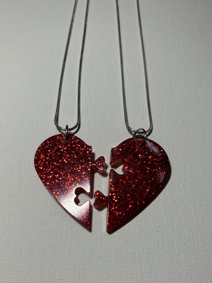 For sale is a handmade matching set of resin puzzle heart necklaces. They are colored red with red sparkles in them. The dimensions are 1 3/4" wide (together) and 1 3/4" long. The chain is 9" long. Please see all pictures for details. Feel free to contact me if you have any questions or would like to order your own style :) Resin Puzzle, Scene Jewelry, Necklaces Red, Heart Puzzle, Heart Necklaces, Best Friend Necklaces, Chandler Az, Red Sparkle, Friend Necklaces