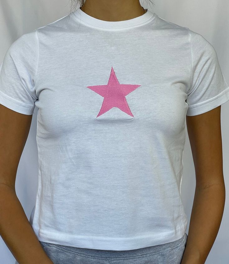 "Star baby tee 100% cotton available in sizes xs - xl - see photo 5 for sizing Model is wearing size S and is a 6/8 - For reference, model is 5'5 with 31\" bust and 26\" waist" Spring Crew Neck T-shirt With Star Print, Summer Cotton T-shirt With Star Patch, Trendy Fitted Tops With Star Print, Fitted Star Print Summer Tops, Fitted Star Print Tops For Summer, Fitted Star Print T-shirt For Summer, Crew Neck Tops With Star Logo For Summer, Fitted Y2k Tops With Star Print, Fitted Star Print Y2k Top