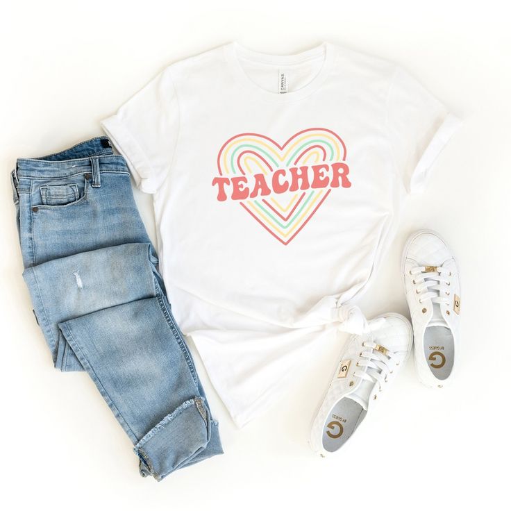 Looking for a cute versatile top to wear this summer? Make sure to grab one of our Colorful Heart Teacher tees! This soft and comfortable graphic tee is the perfect top for any outfit. It can be paired with biker shorts, jeans, or even a simple skirt/dress! This tee is true-to-size, so be sure to order your regular t-shirt size! If you are looking for a more oversized look, make sure to size up! Mauve Blush, Purple Light, Teacher Tees, Colorful Heart, Green Grass, White Ink, Ice Blue, Blue Ocean, Army Green