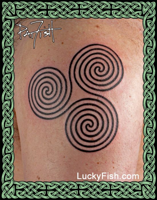 a man with a tattoo on his shoulder that has three spirals in the middle