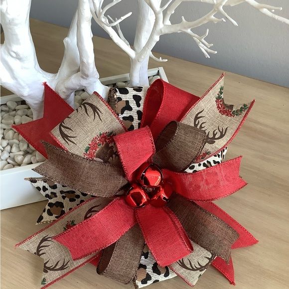 a christmas decoration with red ribbon and reindeer antlers