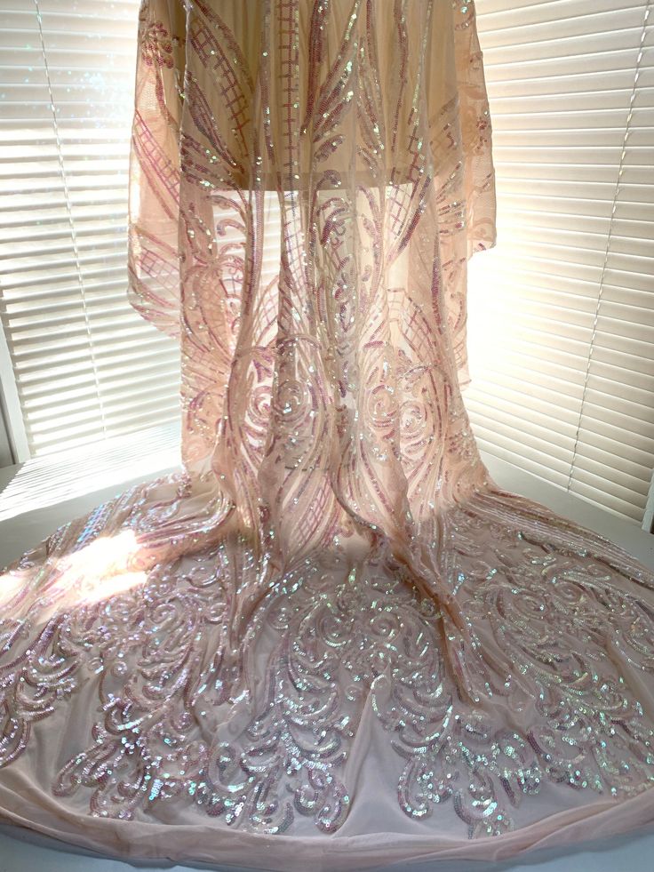 a dress that is sitting on top of a window sill in front of a window