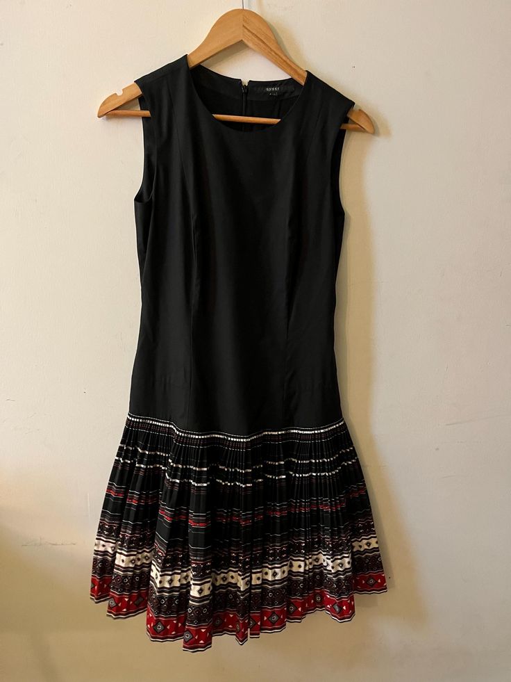 Gucci Dress Made by a black cotton sleeveless with an amazing plissè multicolor skirt  Italian size 42 Measure  Length 95 cm Breast 32 cm Waist 40 cm Gucci Black Dress, Gucci Dress, Multicolor Skirt, Gucci Black, Dress Clothes For Women, Festival Season, Dress Making, Black Cotton, Art Collection