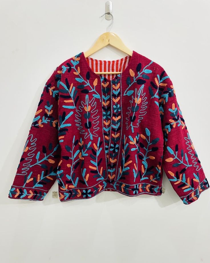 Experience the ultimate blend of luxury and bohemian style with our Suzani Hand-Embroidered Boho Jacket in vibrant Maroon/Blue hues. This exquisite piece, meticulously handcrafted, features intricate Suzani embroidery that radiates elegance and artistic charm. Made from premium Cotton TNT, this jacket is designed to provide both warmth and style, making it the perfect addition to your winter wardrobe. Ideal for both men and women, this versatile jacket is not just a piece of clothing but a state Festive Bohemian Outerwear With Chikankari Embroidery, Bohemian Chikankari Embroidered Outerwear For Fall, Multicolor Outerwear With Woven Motifs For Fall, Bohemian Outerwear With Chikankari Embroidery For Fall, Bohemian Nehru Jacket With Intricate Embroidery For Fall, Bohemian Nehru Jacket With Intricate Embroidery, Bohemian Long Sleeve Outerwear With Intricate Embroidery, Traditional Multicolor Cardigan For Fall, Traditional Multicolor Fall Cardigan