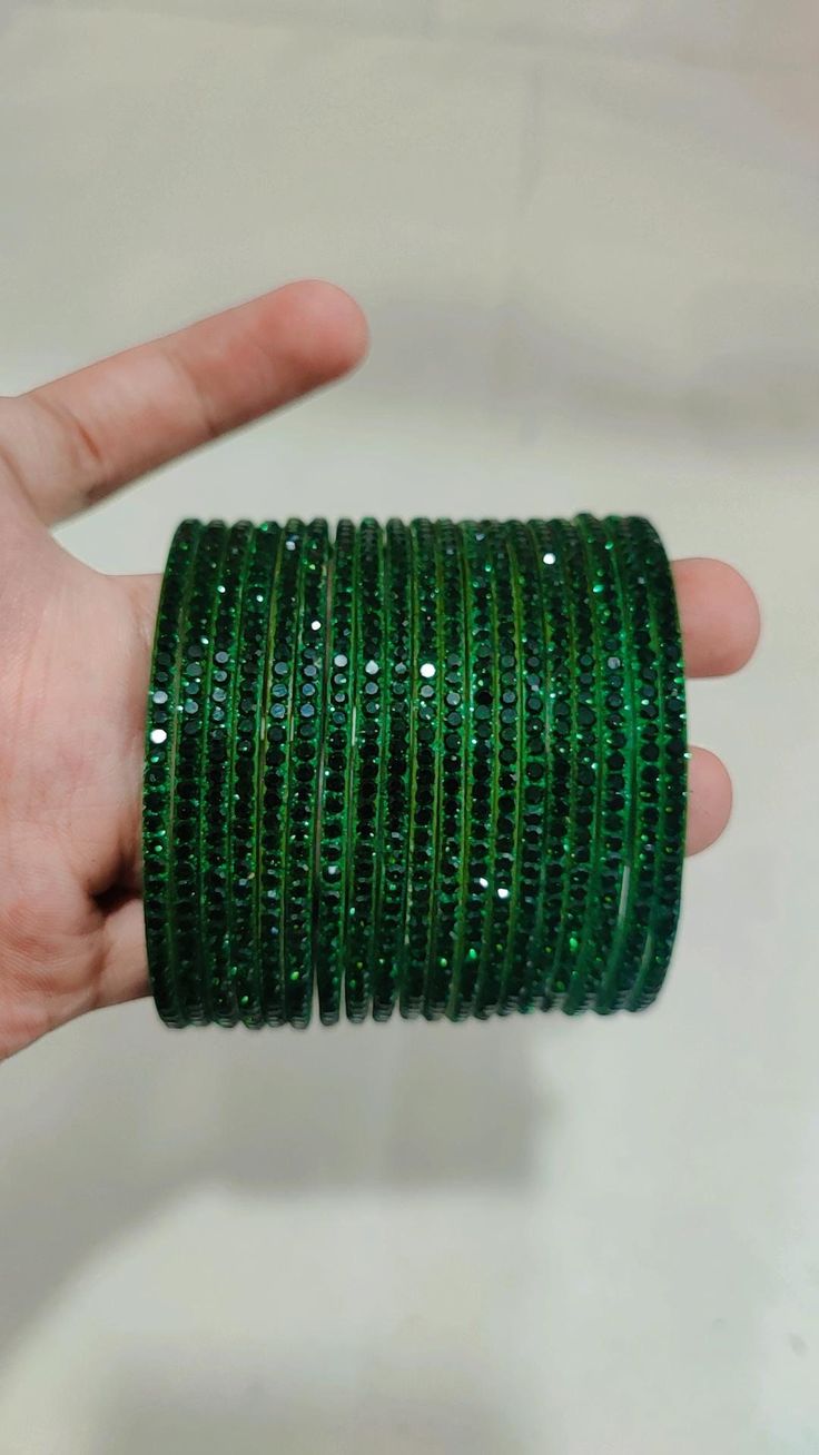 Bangles Name - Penali Burj Khalifa   Color - dark green   Size - 2.2/2.4/2.6/2.8   Weight - 60 grams   Piece - 12   Stone Color- green  100% Glass Bangles & Handmade Product. You can wear it while going to a wedding by matching it with your clothes. You can also gift it to someone. You can also wear it in an engagement. It looks very beautiful in your hands. about shipping  Ships within 1 to 3 business days after payment is received  We ship orders every day except Sundays and holidays  When you Bangles Glass Beautiful, Green Round Bracelets For Party, Green Emerald Bracelets For Party, Adjustable Green Bangle For Party, Adjustable Green Emerald Bracelet, Adjustable Green Round Bangle, Adjustable Green Bangle, Green Bangles, Glass Bracelets