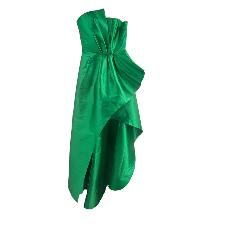 a green dress with a bow on the back