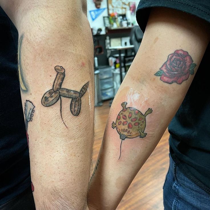 two people with matching tattoos on their arms