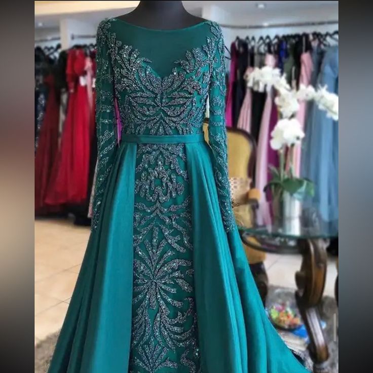 Long Sleeve Dress With Satin Cape. Worn Once. Fits Sizes 8-10 Embroidered Evening Dress For Wedding And Prom Season, Formal Embroidered Fitted Ball Gown, Elegant Embroidered Prom Ball Gown, Floor-length Embroidered Evening Dress For Prom, Embroidered Floor-length Evening Dress For Prom, Embellished Long Sleeve Ball Gown For Prom, Embellished Long Dress For Banquets, Green Embellished Long Sleeve Evening Dress, Embellished Long Dress For Banquet