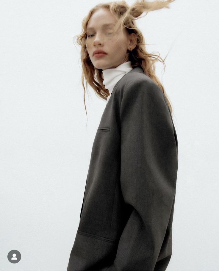 a woman with her hair blowing in the wind