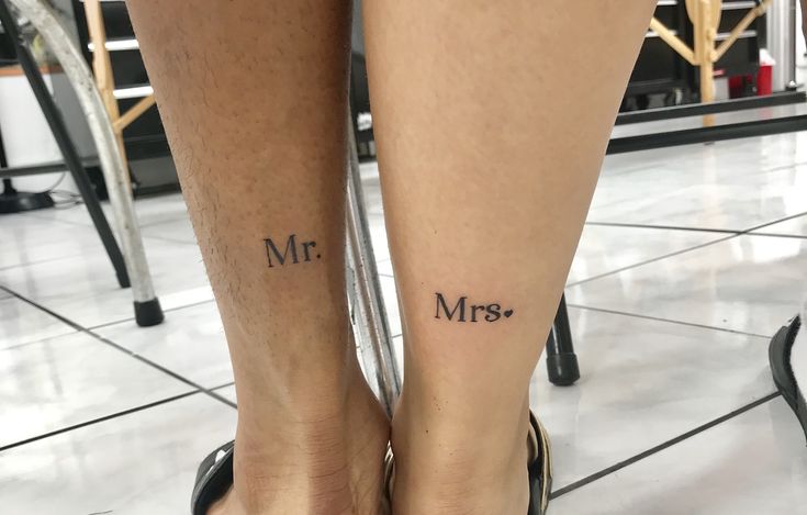 two people with tattoos on their legs and one has the word mr and mrs tattooed on them