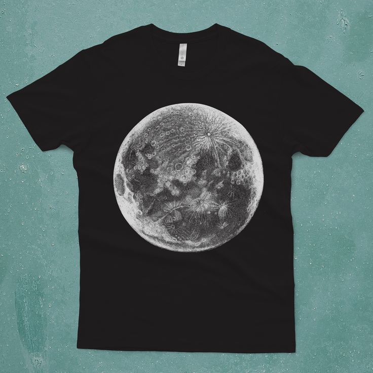 a black t - shirt with an image of the moon on it