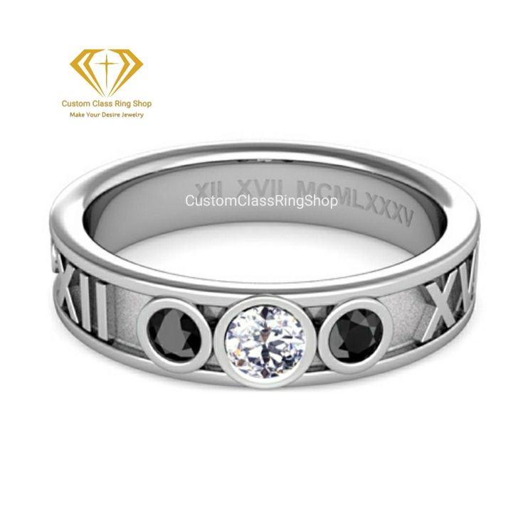 a white gold ring with roman numerals and three black diamonds on the side