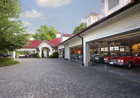 an image of a garage with cars parked in the driveway and on the other side