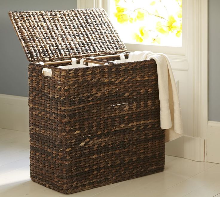 a wicker basket sitting on top of a white floor next to an open window