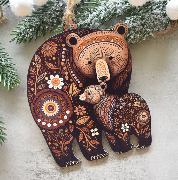 an ornament with a bear and cub on it