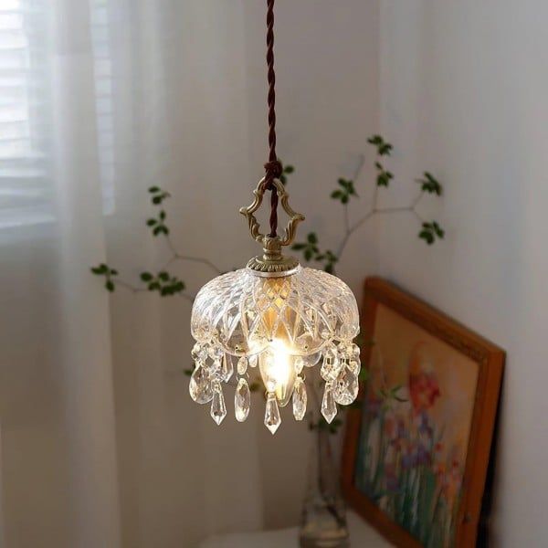 a chandelier hanging from a ceiling in a room with a painting on the wall