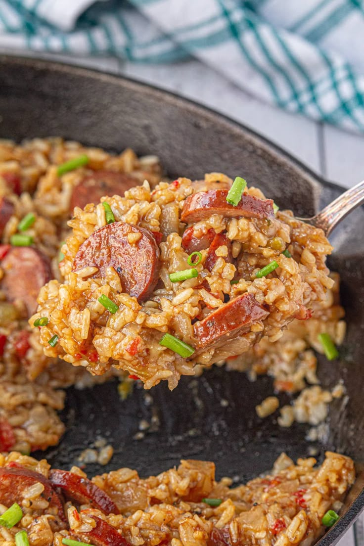 a skillet filled with rice and sausage