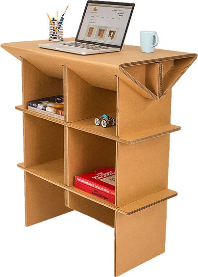 an open laptop computer sitting on top of a cardboard book shelf next to a cup