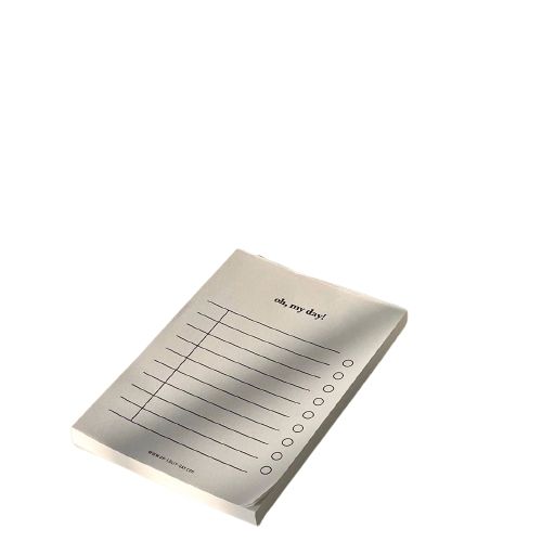 a notepad is sitting on top of a white surface with lines and dots in the middle