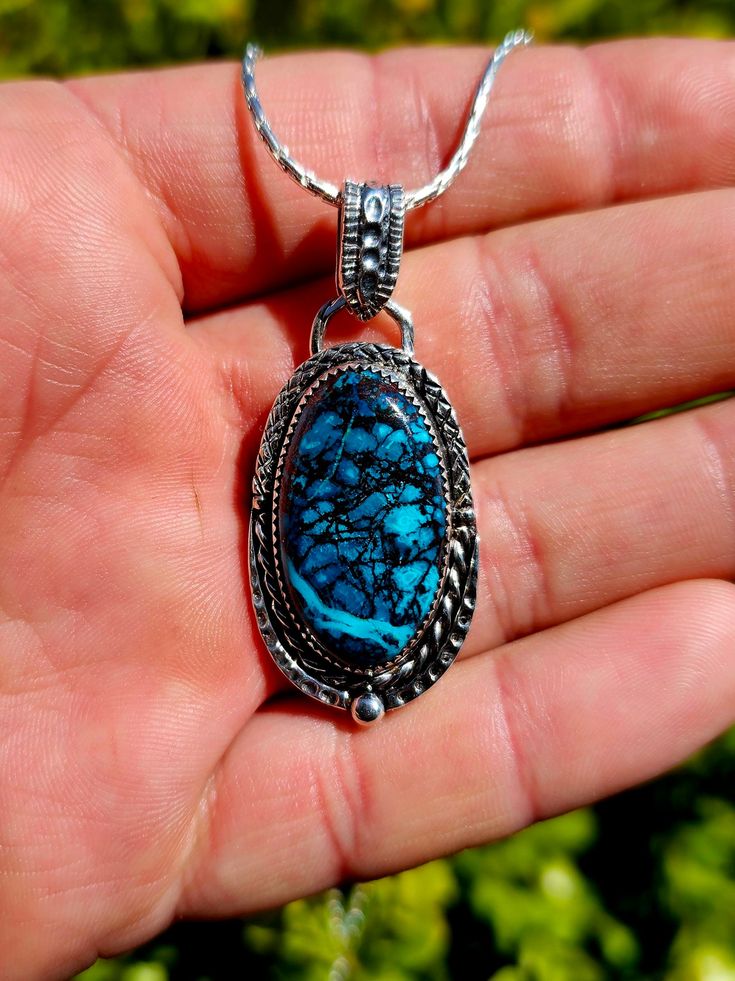 This 100% handmade pendant is made from a beautiful self cut and polished Chrysocolla specimen, and has been crafted into a custom one of a kind 925 silver setting that you won't find anywhere else. The visual with a deep blue that looks at the bottom of the sea is like a universe. It is a power stone that attracts what you see. Chrysocolla is a stone that is strong in calmness and sustainability, and has a lot of energy for healing. It removes all the negative power surrounding the owner and brings you positive energy. The pendants height (not including the bail) is 34.5mm and the width is 21mm at its widest point.  If you have any questions or other inquiries, please feel free to message me through the app. Large Chrysocolla Pendant Jewelry, Handmade Chrysocolla Oval Pendant Jewelry, Silver Chrysocolla Necklace With Large Stone, Handmade Oval Pendant With Gemstone, Silver Chrysocolla Cabochon Necklace, Silver Chrysocolla Pendant Necklace, Chrysocolla Large Pendant Jewelry Gift, Chrysocolla Large Pendant Jewelry For Gift, Silver Chrysocolla Jewelry With Natural Stones