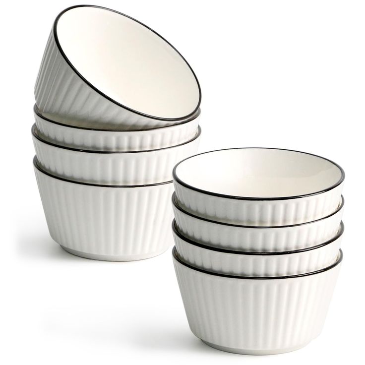 four white dishes stacked on top of each other