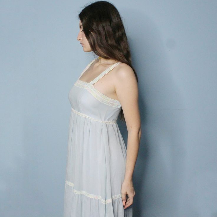 Vintage 80s 2 Piece Prairie Dress set! Pastel Blue Cottagecore DREAM. Light layered maxi sundress style dress with multicolored lace detail, empire waist, spaghetti straps, and little floaty matching dress topper/capelet. So Elegant and angelic! Some very light discolorationsBust: 33"Empire Waist: 29 1/2"Natural Waist: 31"Hips: 34"Hips: 55" 12.7 Airy Sleeveless Maxi Dress For Daywear, Summer Midi Dress With Lace Trim For Daywear, Spring Maxi Dress With Lace Trim And Square Neck, Flowy Midi Dress With Lace Trim For Summer, Lace Trim Slip Dress For Spring, Bohemian Vintage Dress With Lace Trim For Summer, Blue Lined Vintage Dress For Summer, Summer Vintage Midi Dress For Daywear, Summer Maxi Dress With Lace Trim For Casual Wear