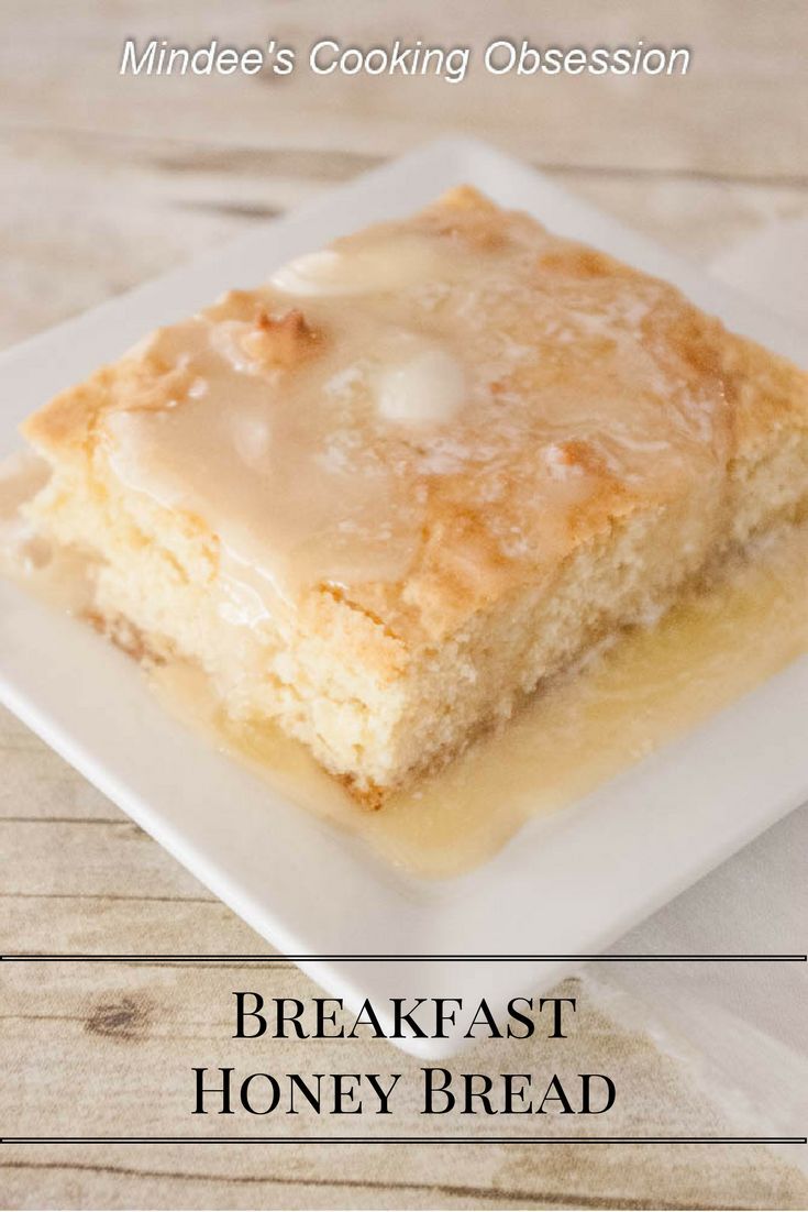 a white plate topped with a piece of bread covered in icing