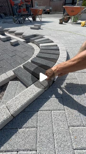 a man is cutting through some bricks with a knife