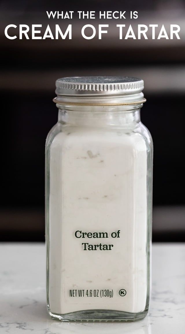 a jar filled with cream sitting on top of a counter